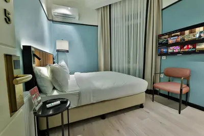 a hotel room with a bed and a chair at EA Exclusive Hotel in Istanbul