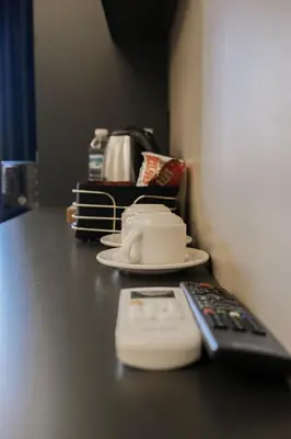 a remote control sitting on top of a counter next to a remote control at Plus Hotel & Private Transportation İstanbul Airport-By Loft in Arnavutköy