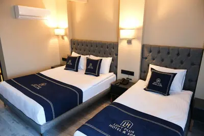 two beds in a hotel room with blue and white at Plus Hotel & Private Transportation İstanbul Airport-By Loft in Arnavutköy