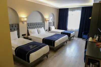 a hotel room with two beds and a window at Plus Hotel & Private Transportation İstanbul Airport-By Loft in Arnavutköy