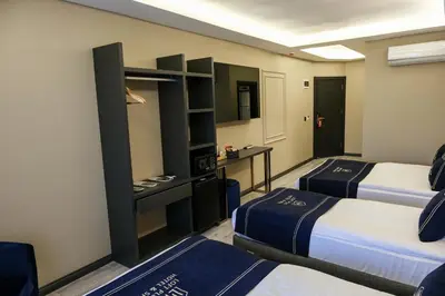 a hotel room with two beds and a desk at Plus Hotel & Private Transportation İstanbul Airport-By Loft in Arnavutköy