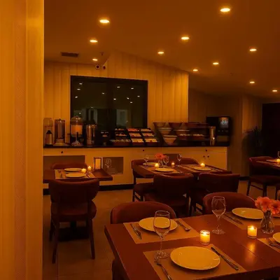 a restaurant with tables and chairs and a kitchen at Istanbul Midpoint Hotel in Istanbul