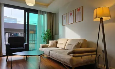 a living room with a couch and a table and a chair at Elysium Soul Residence in Istanbul