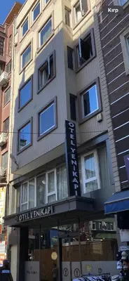 a tall building with a sign in front of it at Otel Yenikapı in Istanbul