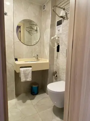a bathroom with a toilet and a sink and a mirror at Otel Yenikapı in Istanbul