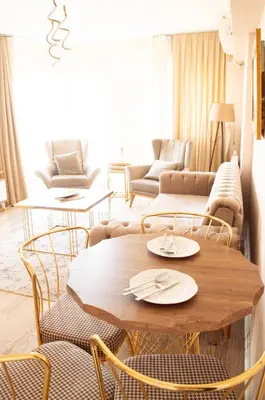 a living room with a wooden table and chairs at Deluxe King Suite AS3 in Esenyurt