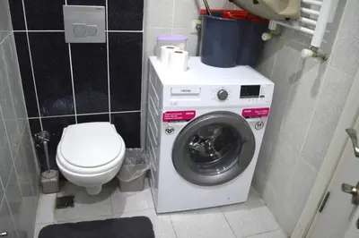 a bathroom with a washing machine and a toilet at Deluxe King Suite AS3 in Esenyurt