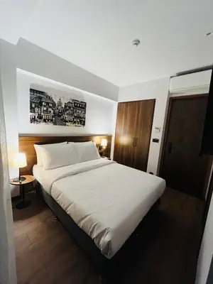 a bedroom with a large bed with white sheets at PALMERA HAGIA SOPHIA Hotel in Istanbul