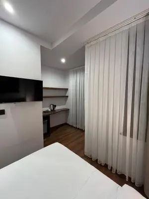 a bedroom with a white bed and a window with curtains at PALMERA HAGIA SOPHIA Hotel in Istanbul