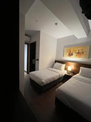 a bedroom with two beds and a painting on the wall at PALMERA HAGIA SOPHIA Hotel in Istanbul