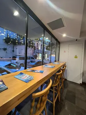 a long table in a restaurant with windows at PALMERA HAGIA SOPHIA Hotel in Istanbul