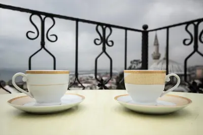 two coffee cups sitting on a table on a balcony at Sultanahmet Black Pearl Apart Hotel in Istanbul