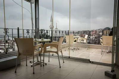 a restaurant with a table and chairs on a balcony at Sultanahmet Black Pearl Apart Hotel in Istanbul