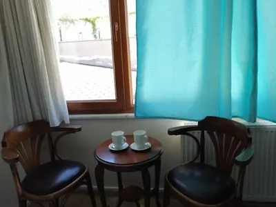 a table with two chairs and two mugs on it at Sultanahmet Black Pearl Apart Hotel in Istanbul