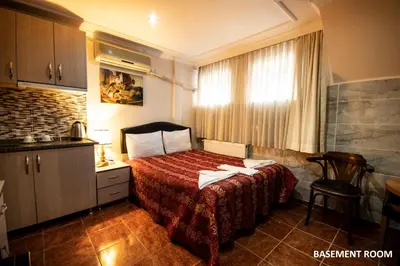 a hotel room with a bed with a red bedspread at Sultanahmet Black Pearl Apart Hotel in Istanbul