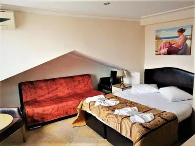 a hotel room with a bed with two towels on it at Sultanahmet Black Pearl Apart Hotel in Istanbul