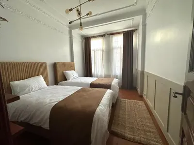 a hotel room with two beds and a window at Botter Dream House in Istanbul