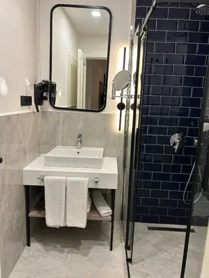 a bathroom with a sink and a mirror at Prime Bosphorus Hotel in Istanbul