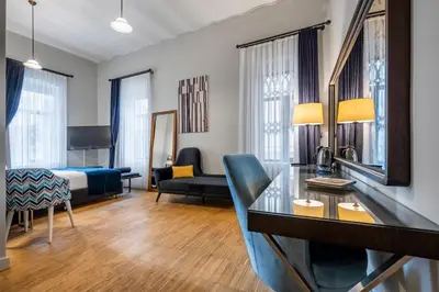 a hotel room with a king bed and a desk at DeCamondo Residence in Istanbul