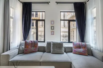 a living room with a couch and two windows at DeCamondo Residence in Istanbul