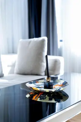 a plate with a candle on a glass table at DeCamondo Residence in Istanbul