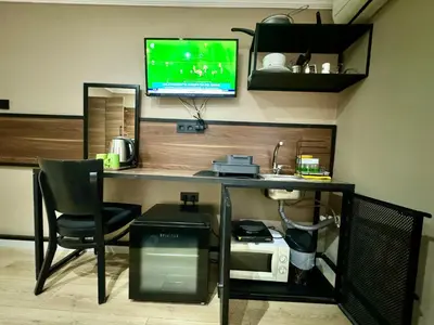 a desk with a computer and a chair in a room at Aram Kerasi Rooms in Istanbul