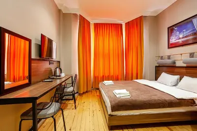 a bedroom with a bed and a desk with a computer at Aram Kerasi Rooms in Istanbul