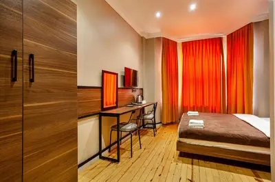 a hotel room with a bed and a desk and a bedroom at Aram Kerasi Rooms in Istanbul
