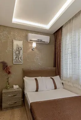 a bedroom with a bed and a air conditioner at Carvan hotel in Istanbul