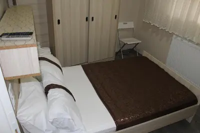 a bedroom with a bed with a desk and a chair at Carvan hotel in Istanbul