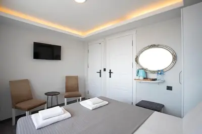 a white room with a table and a mirror at Carvan hotel in Istanbul