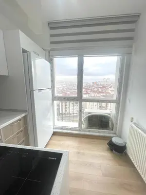 a kitchen with a large window with a view of a city at Two Bedroom King Suite IH19 in Esenyurt