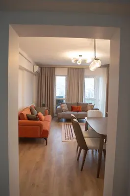 a living room with a couch and a table at Two Bedroom King Suite IH19 in Esenyurt
