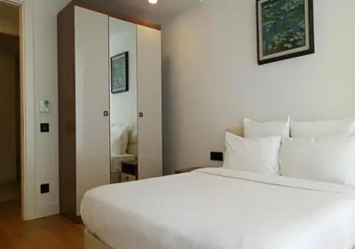 a bedroom with a large white bed and a mirror at Prime Istanbul in Istanbul