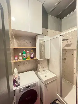 a small bathroom with a sink and a washing machine at TAKSİM PERA House in Istanbul