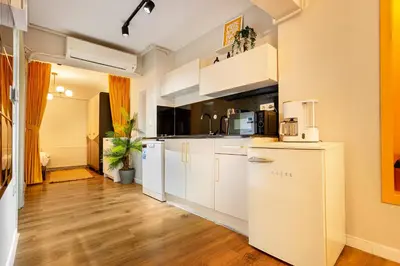 a kitchen with white appliances and wooden floors at Port Galata Suites in Istanbul