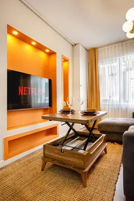 a living room with a television and a coffee table at Port Galata Suites in Istanbul