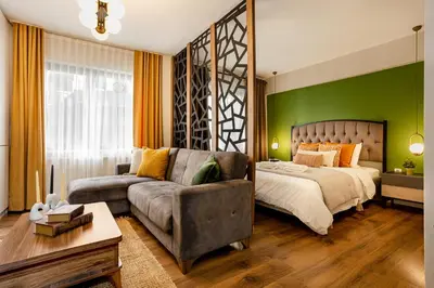 a bedroom with a bed and a couch at Port Galata Suites in Istanbul
