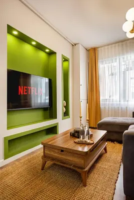 a living room with a tv and a coffee table at Port Galata Suites in Istanbul
