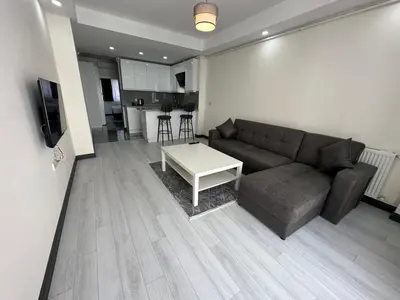 a living room with a couch and a table at Rose Plus Residence in Istanbul