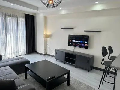 a living room with a couch and a flat screen tv at Rose Plus Residence in Istanbul