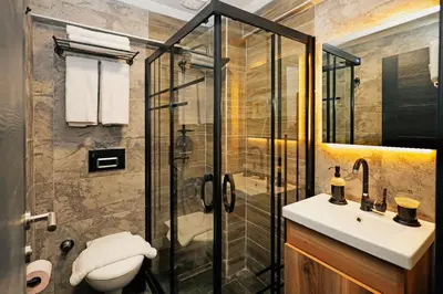 a bathroom with a shower and a toilet and a sink at Galata Master Hotel in Istanbul
