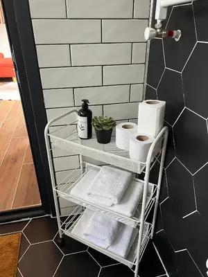 a towel rack with towels and toilet paper at Pentalow Cabin in Kocaeli