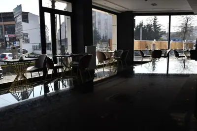 a restaurant with tables and chairs in a room with windows at Hmz LUXURY HOTEL in Çekmeköy