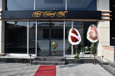 a christmas store front with santa claus wreaths on the windows at Hmz LUXURY HOTEL in Çekmeköy