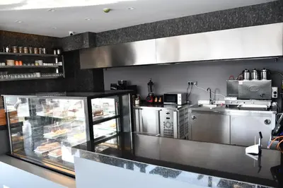 a restaurant kitchen with a counter and a counter at Hmz LUXURY HOTEL in Çekmeköy