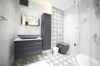 a bathroom with a sink and a toilet and a shower at Modern Super Chic Duplex with a Terrace at the heart of city! in Istanbul