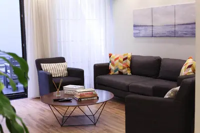 a living room with a couch and a coffee table at Modern Super Chic Duplex with a Terrace at the heart of city! in Istanbul