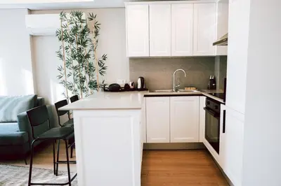 a kitchen with white cabinets and a counter top at Bolahenk Suites in Istanbul