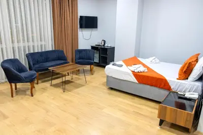 a hotel room with a bed and two chairs and a table at ZOOM HOTEL in Istanbul